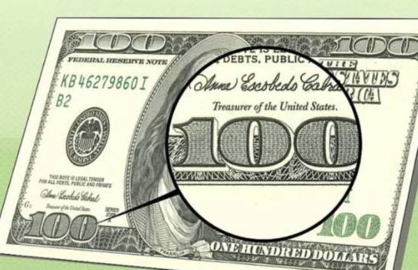 正常光源看防伪线将纸币置於光源下,除了一美元和两美元,其余都右一