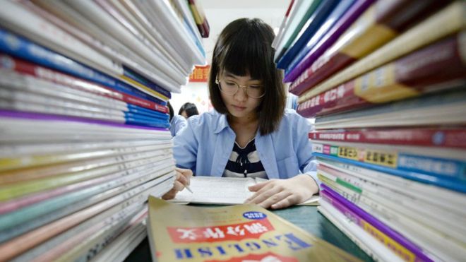 Chinese teenager reading in class